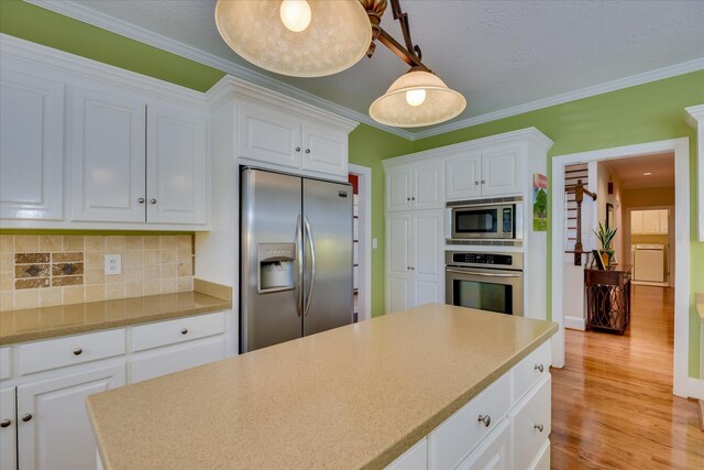 3501 Lonesome Pine Ct, Martinez, GA 30907 - kitchen featuring appliances with stainless steel finishes, tasteful backsplash, light wood finished floors, white cabinets, and light countertops