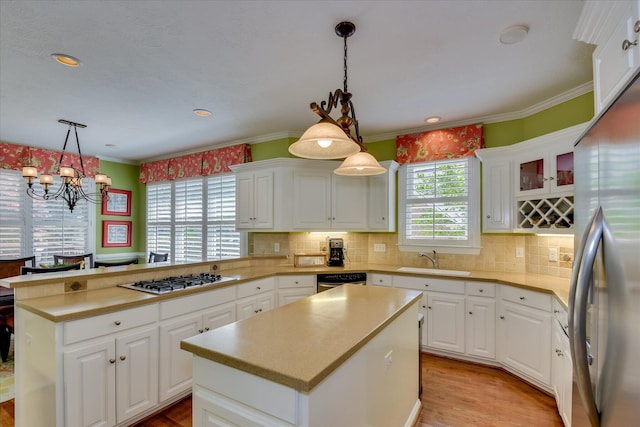 3501 Lonesome Pine Ct, Martinez, GA 30907 - kitchen featuring appliances with stainless steel finishes, a sink, a chandelier, a peninsula, and plenty of natural light