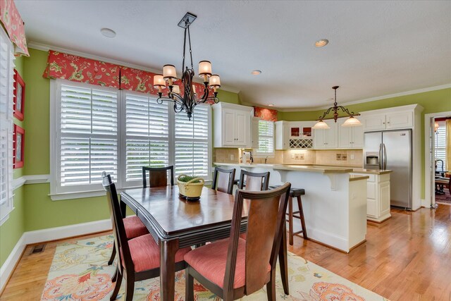 3501 Lonesome Pine Ct, Martinez, GA 30907 - dining area with a chandelier, light wood-style floors, crown molding, baseboards, and recessed lighting
