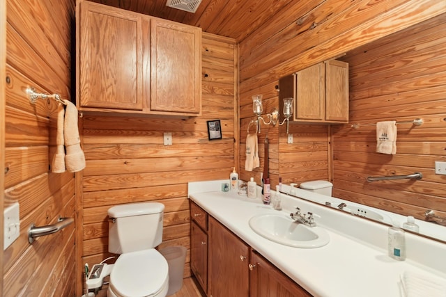 bathroom featuring vanity, wood walls, toilet, and wooden ceiling
