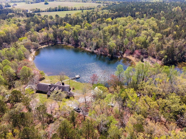 aerial view with a forest view and a water view