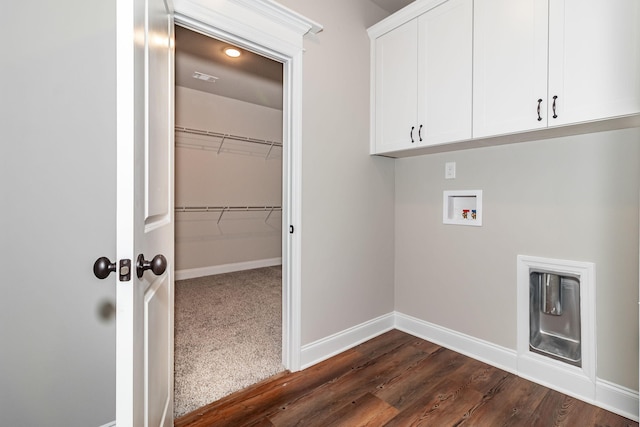 clothes washing area with dark wood-style floors, hookup for a washing machine, cabinet space, and baseboards