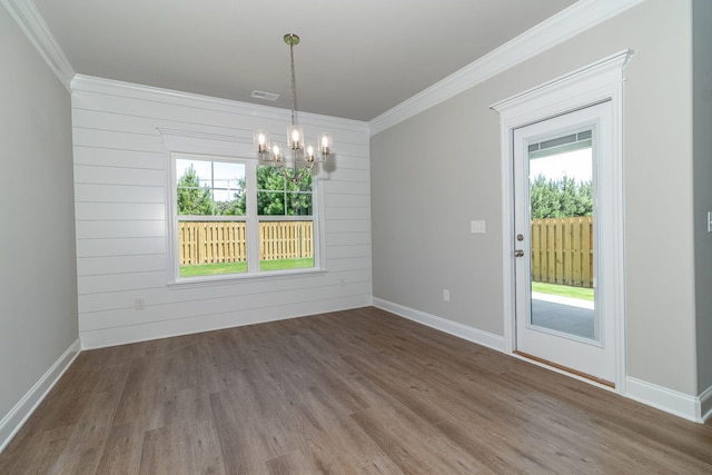 unfurnished room featuring ornamental molding, visible vents, plenty of natural light, and wood finished floors