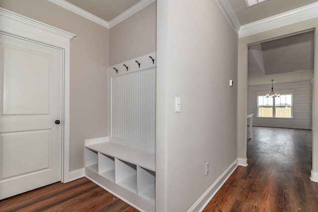 mudroom featuring a chandelier, dark wood-type flooring, ornamental molding, and baseboards