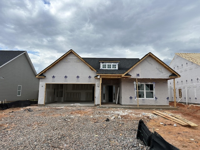 property in mid-construction featuring a garage, a shingled roof, and stucco siding