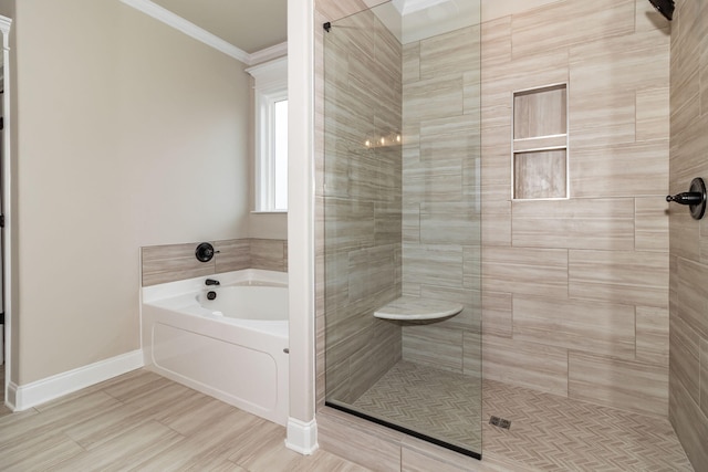 full bathroom with baseboards, a tile shower, a bath, and crown molding