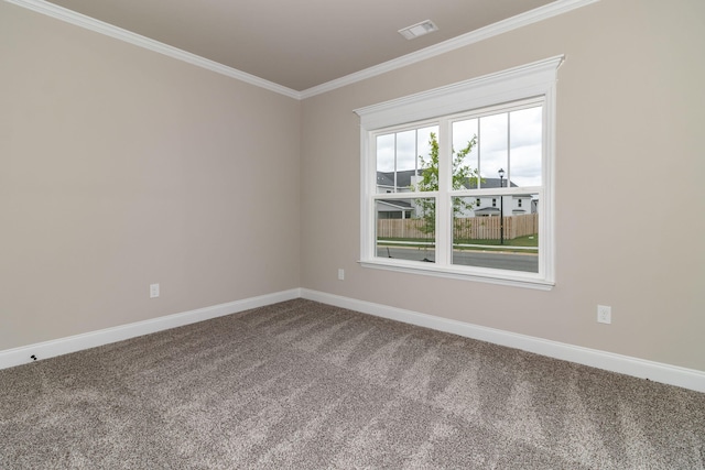 unfurnished room featuring carpet, visible vents, baseboards, and ornamental molding