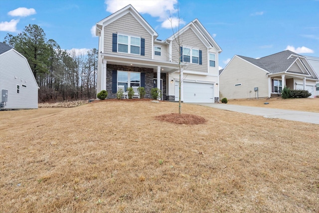 view of front of house featuring stone siding, a front yard, concrete driveway, and an attached garage