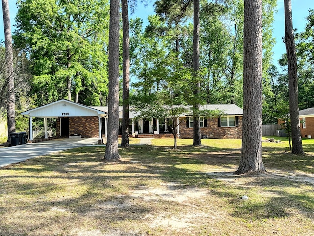 1735 Goshen Rd, Augusta, GA 30906 - ranch-style house featuring fence, brick siding, concrete driveway, an attached carport, and a front yard