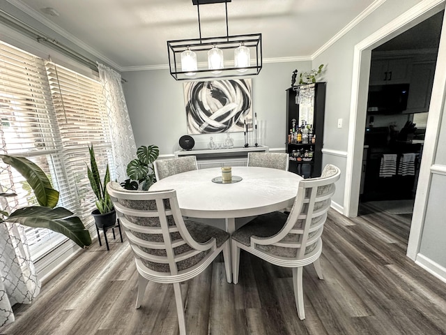 1735 Goshen Rd, Augusta, GA 30906 - dining space with a dry bar, ornamental molding, dark wood-style floors, and baseboards