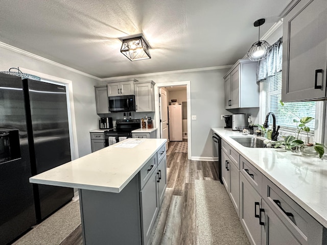 1735 Goshen Rd, Augusta, GA 30906 - kitchen with black appliances, gray cabinets, and wood finished floors