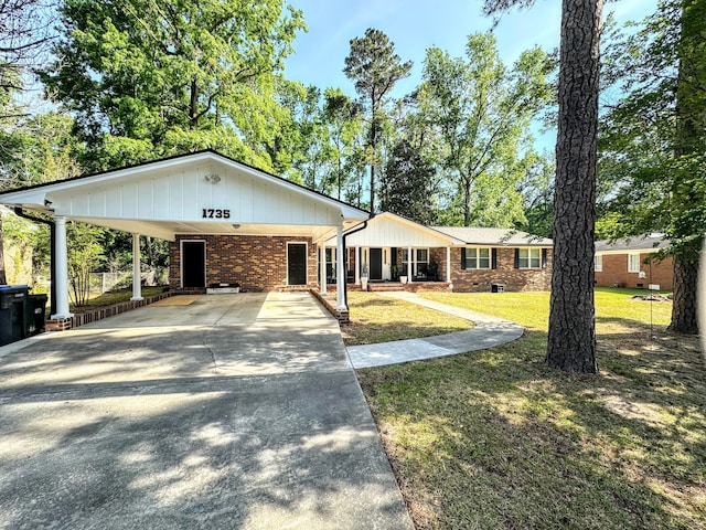 1735 Goshen Rd, Augusta, GA 30906 - view of front of house with brick siding, driveway, a front yard, and an attached carport