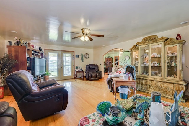 living room with ceiling fan, french doors, and hardwood / wood-style flooring