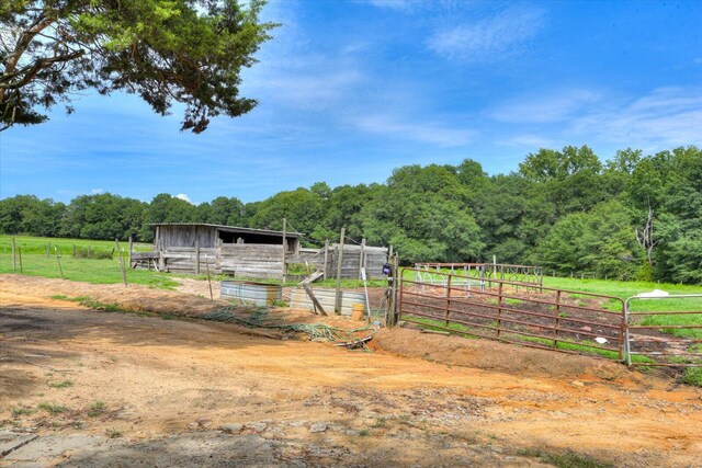 view of yard featuring a rural view and an outbuilding