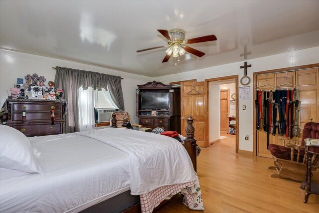 bedroom featuring ceiling fan, cooling unit, and light hardwood / wood-style floors