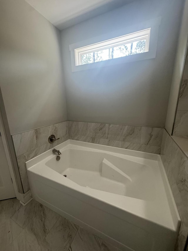 314 Hancock Cir, Mccormick, SC 29835 - bathroom with plenty of natural light, a bath, and marble look tile flooring