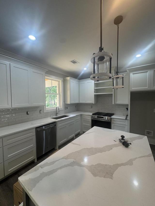 314 Hancock Cir, Mccormick, SC 29835 - kitchen featuring appliances with stainless steel finishes, a sink, decorative backsplash, recessed lighting, and light stone countertops