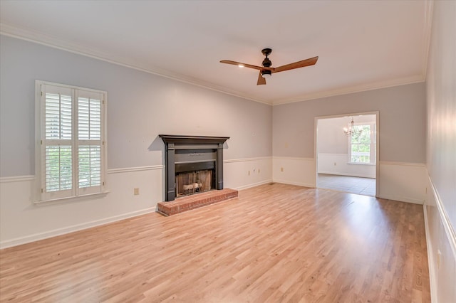 227 Water Oak Dr, Augusta, GA 30904 - unfurnished living room featuring wood finished floors, a ceiling fan, ornamental molding, a fireplace, and a chandelier
