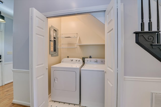 227 Water Oak Dr, Augusta, GA 30904 - laundry area featuring independent washer and dryer, electric panel, light wood-style flooring, and crown molding