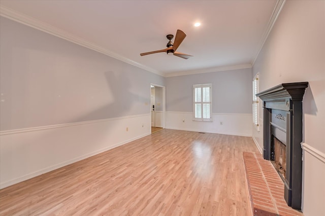 227 Water Oak Dr, Augusta, GA 30904 - unfurnished living room featuring a fireplace, ornamental molding, a ceiling fan, light wood-style flooring, and wainscoting