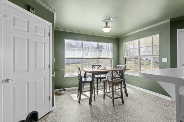 dining area with plenty of natural light, visible vents, ornamental molding, and baseboards