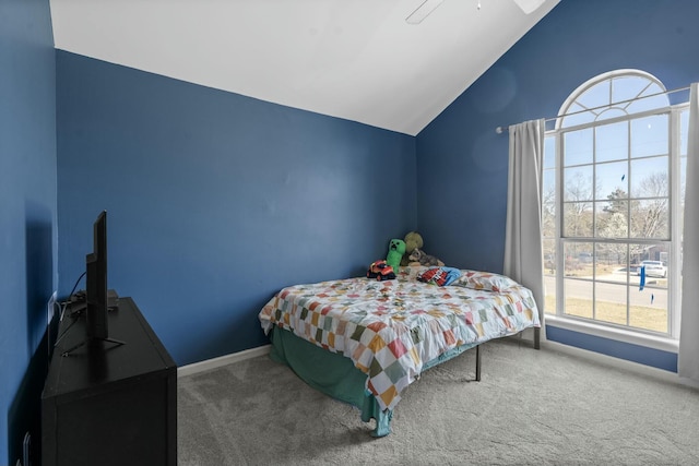 carpeted bedroom with lofted ceiling and baseboards