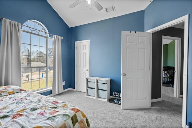 bedroom featuring lofted ceiling, multiple windows, carpet, and visible vents