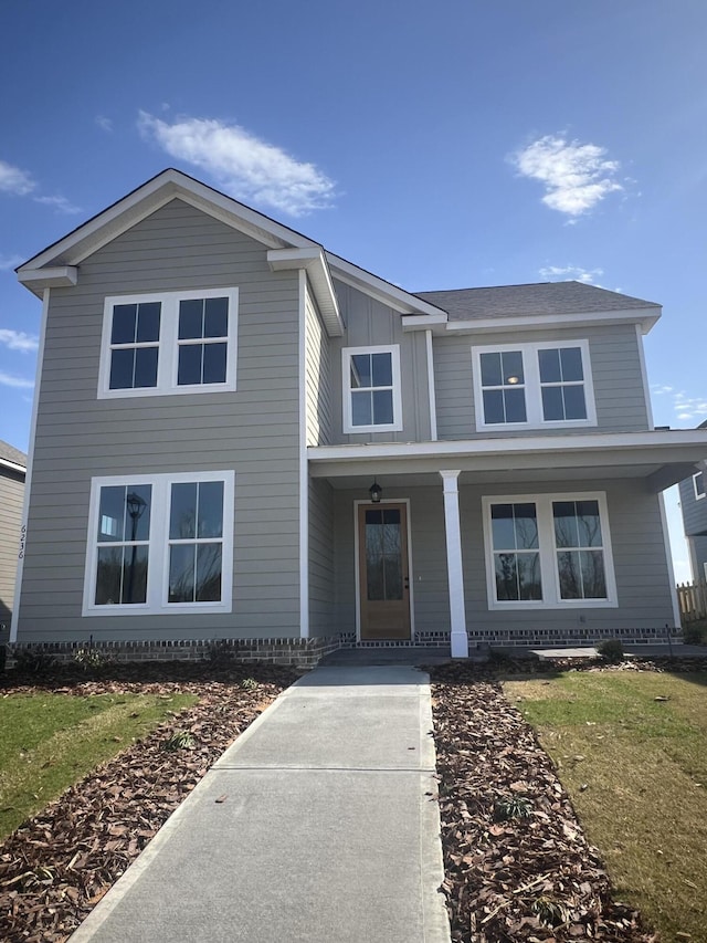 traditional home with a porch and board and batten siding