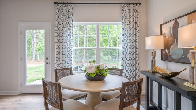 dining space with light hardwood / wood-style flooring