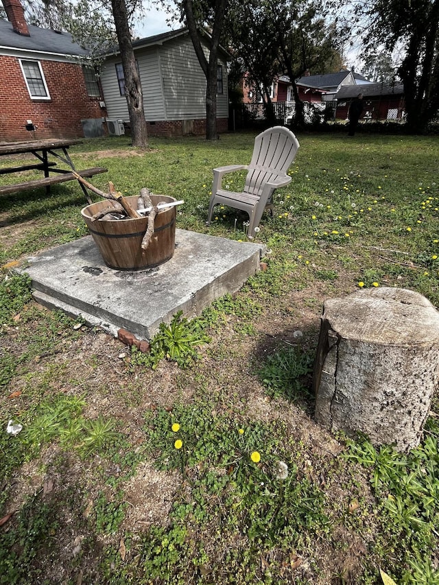 view of yard with an outdoor fire pit and fence