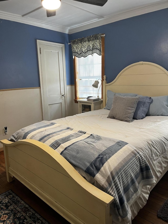 bedroom featuring a ceiling fan, hardwood / wood-style floors, and crown molding