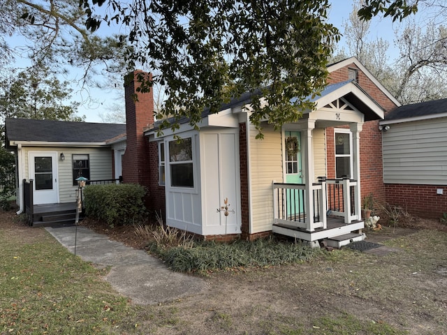 view of front of house featuring a chimney