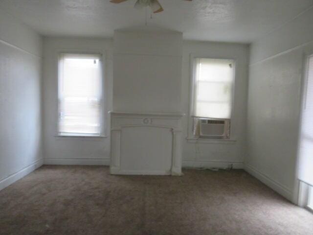 unfurnished room featuring carpet flooring, ceiling fan, and plenty of natural light