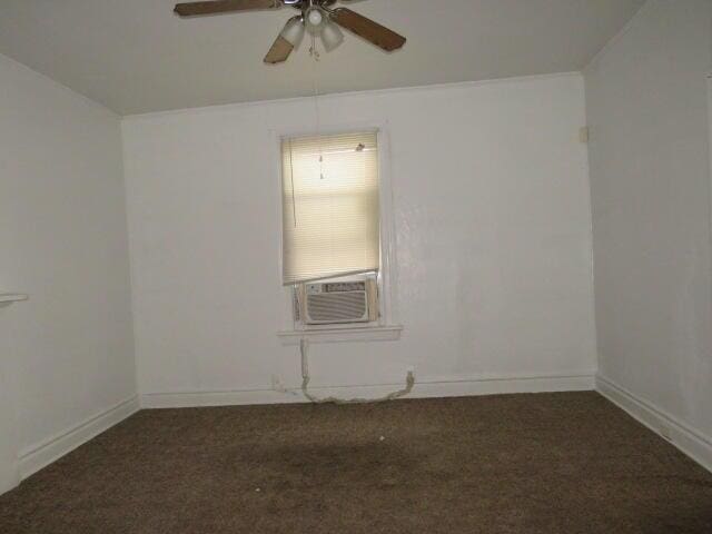 carpeted spare room featuring cooling unit and ceiling fan