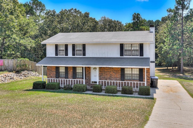 view of front of house with covered porch and a front yard