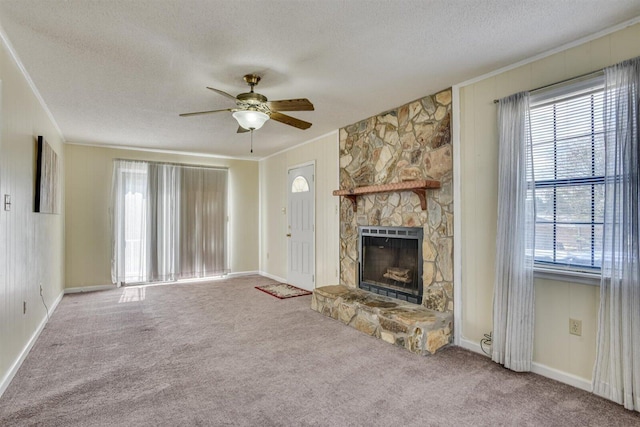 unfurnished living room featuring carpet flooring, ceiling fan, ornamental molding, and a fireplace