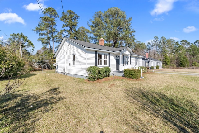 view of home's exterior with a yard and a chimney