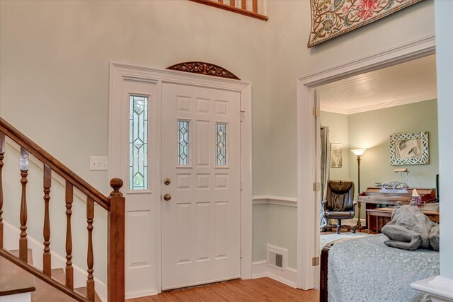 710 Somerset Way, Augusta, GA 30909 - foyer entrance with light wood finished floors, stairway, and crown molding