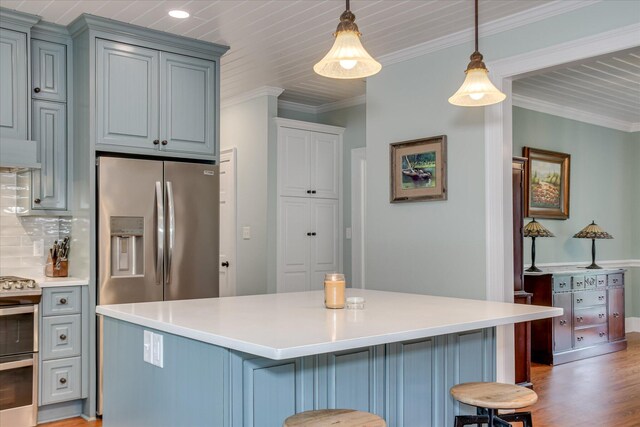 710 Somerset Way, Augusta, GA 30909 - kitchen with appliances with stainless steel finishes, light wood-style floors, a kitchen breakfast bar, light countertops, and crown molding