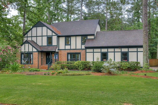710 Somerset Way, Augusta, GA 30909 - tudor home featuring roof with shingles, a front lawn, and brick siding