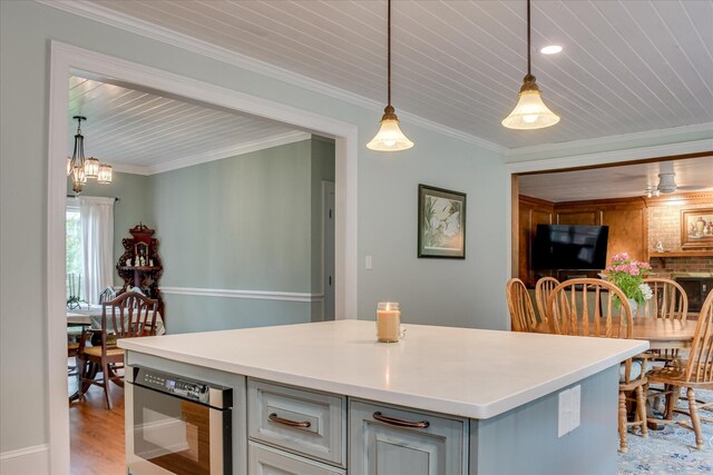 710 Somerset Way, Augusta, GA 30909 - kitchen with gray cabinetry, hanging light fixtures, light countertops, light wood-type flooring, and ornamental molding