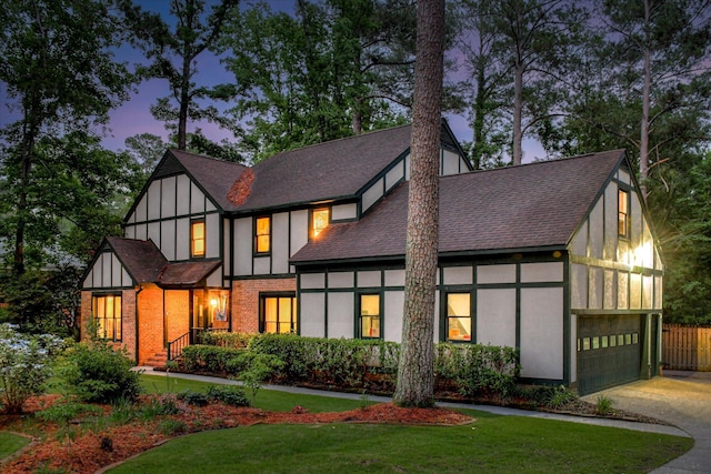 710 Somerset Way, Augusta, GA 30909 - tudor house featuring driveway, a yard, roof with shingles, and a garage
