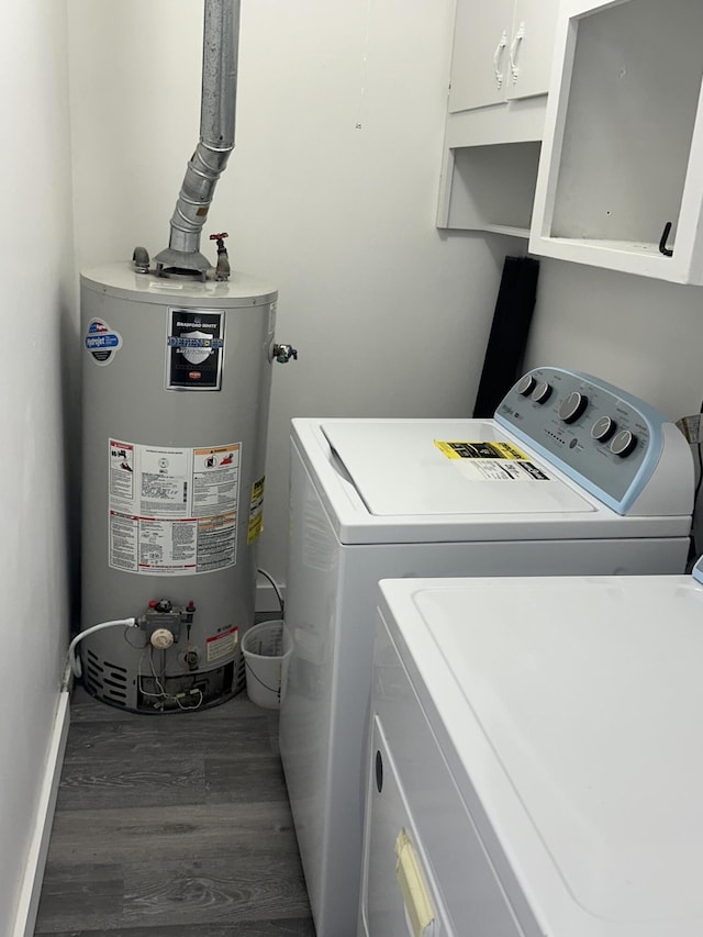 laundry room featuring separate washer and dryer, gas water heater, dark hardwood / wood-style floors, and cabinets