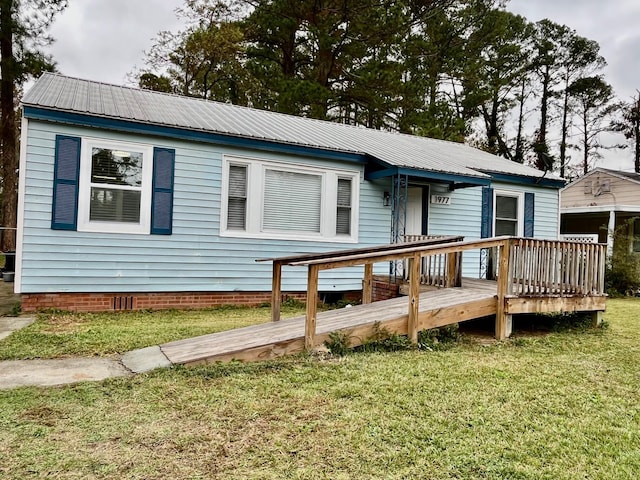 view of front of property with a front yard and a deck