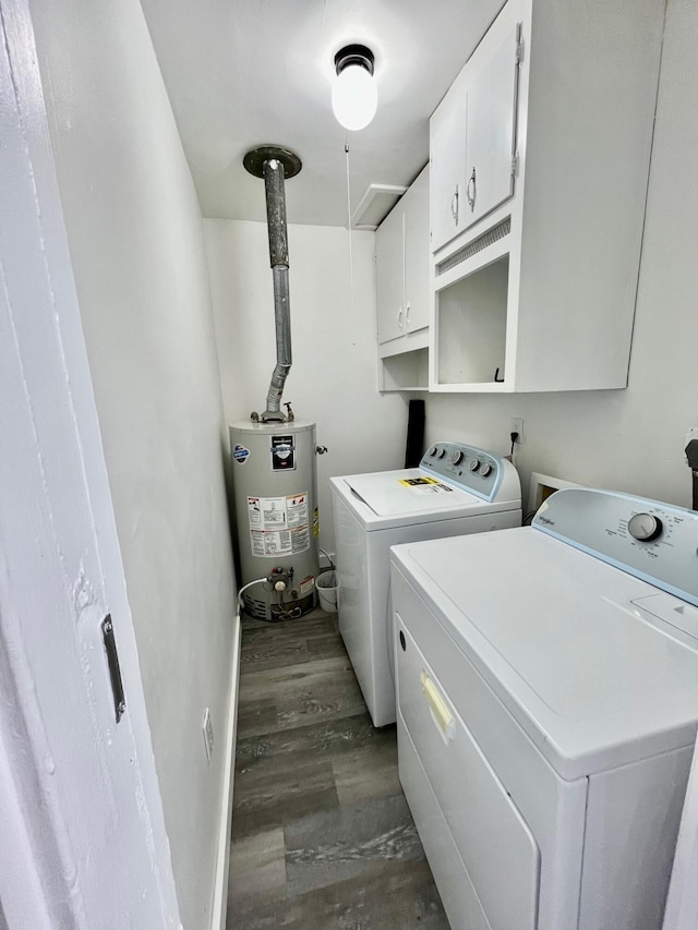 laundry area with washing machine and clothes dryer, dark wood-type flooring, cabinets, and water heater