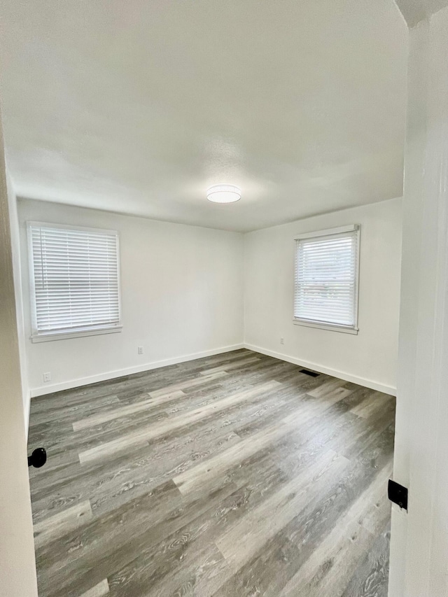 empty room with hardwood / wood-style floors