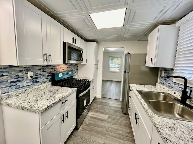 kitchen with white cabinets, sink, and appliances with stainless steel finishes