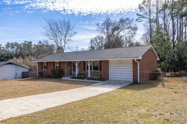 ranch-style home with a garage, a front yard, and covered porch