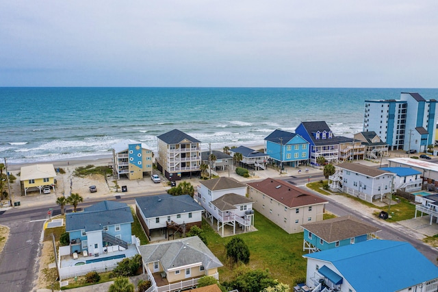 drone / aerial view featuring a water view and a view of the beach