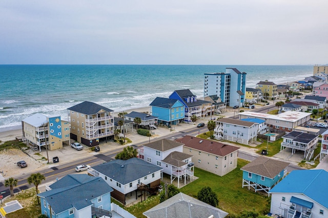 birds eye view of property with a beach view and a water view